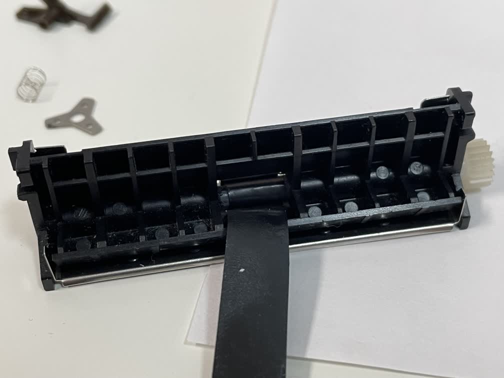 Winding electrical tape onto the paper feeder